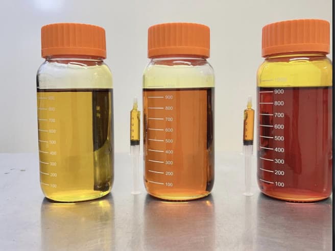 Three color grades of wholesale cannabis distillate in lab bottles — Waseca MN cannabis extraction facility